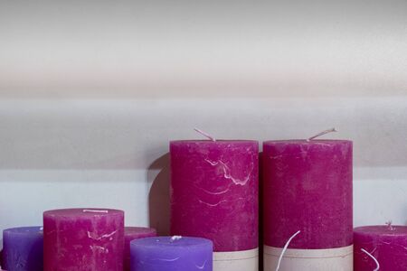 Colorful stick candles arranged in shelves and sorted by color in a candle shop.の写真素材