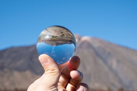 A view of volcano Mount Teide through crystal globe, in Teide National Park, in Tenerife, the...