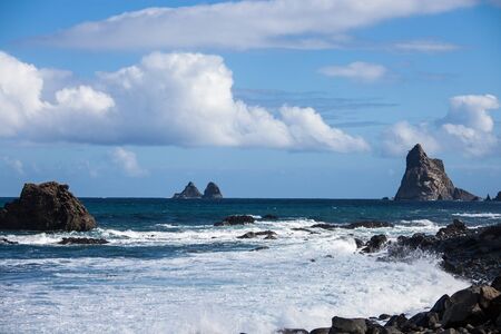 Seaside resort on Tenerife island. Ocean on a summer day, waves. Tourism and travel, vacation. Panoramic landscape.の写真素材