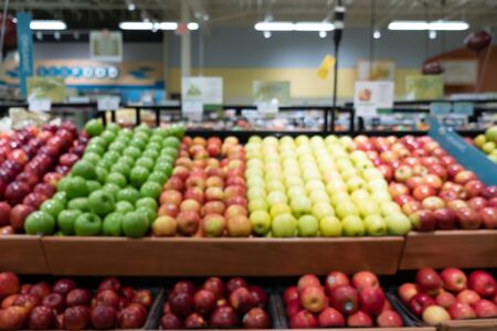 Abstract blur supermarket interior with apples and fresh fruits backgroundの写真素材