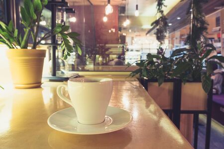 closeup image of coffee cup at cafe table. Cafe interiorの写真素材