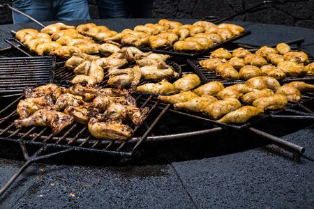 Chicken thighs on the natural volcanic stove grillの写真素材