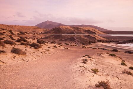 Sand desert dunes and sea beach landscape at sunrise