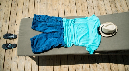 Beach items with straw hat, flip flops and sunglasses