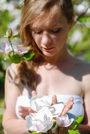 Beautiful Spring Girl with the magnolia flowersの写真素材