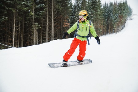 a portrait of a female snowboarder staying on board