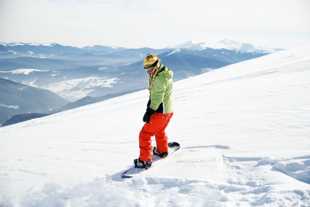 a portrait of a female snowboarder staying on boardの写真素材