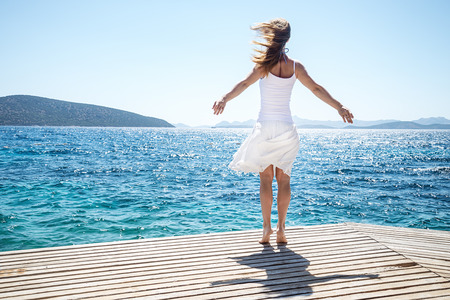 Young woman jumping on the beachの写真素材
