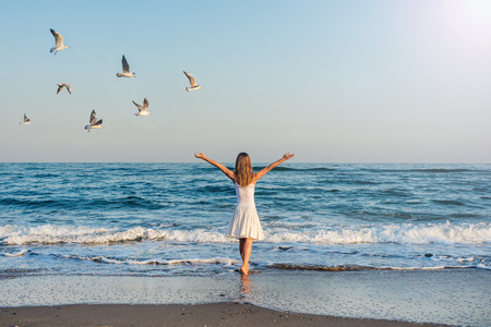 Girl standing at the beachの写真素材