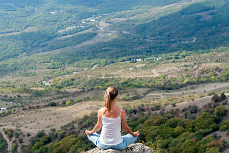 Woman Meditate at the Mountainsの写真素材