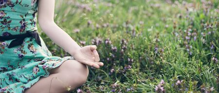 Pretty woman meditate in the parkの写真素材