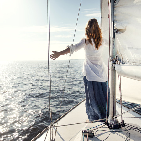 woman staying on sailboatの写真素材