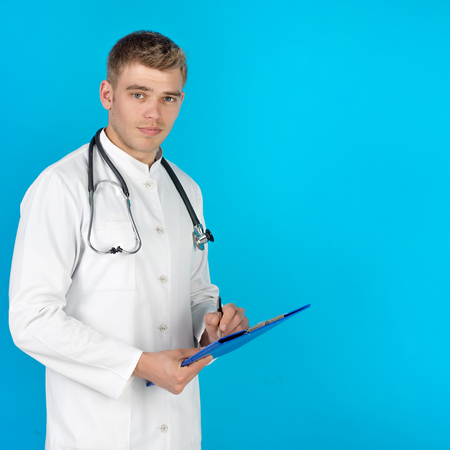 Portrait Of A Doctor Looking At Camera Isolated On Blue Backgroundの写真素材