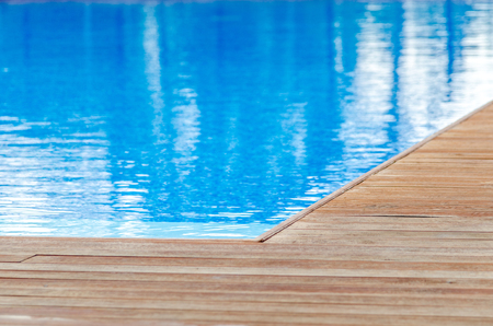 Swimming pool and wooden deck ideal for backgroundsの写真素材