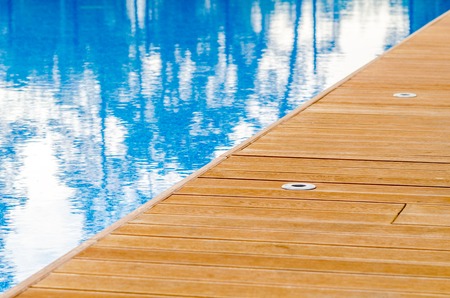 Swimming pool and wooden deck ideal for backgroundsの写真素材