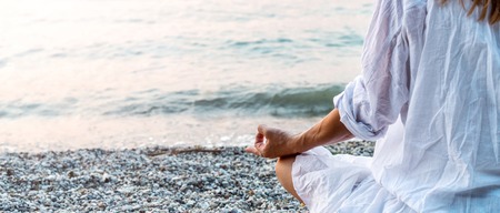 Woman meditating at the seaの写真素材