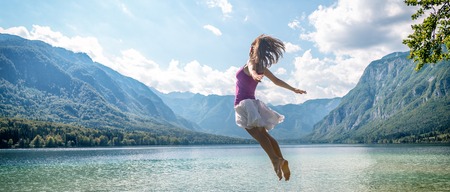 Girl jumping on the lakeの写真素材