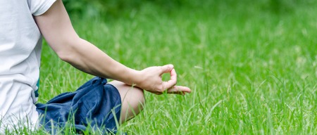 Woman doing yoga in the parkの写真素材