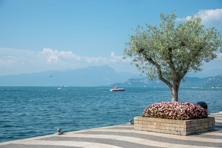 shore of Lake Garda with Alps mountain, Italyの写真素材