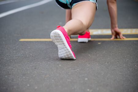 feet running on road closeup on shoe