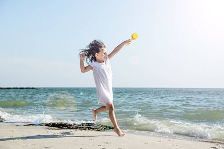 Happy little girl on the beachの写真素材