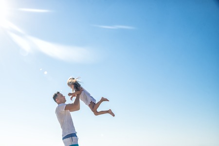 Father and his little daughter at the seaの写真素材