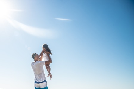 Father and his little daughter at the seaの写真素材