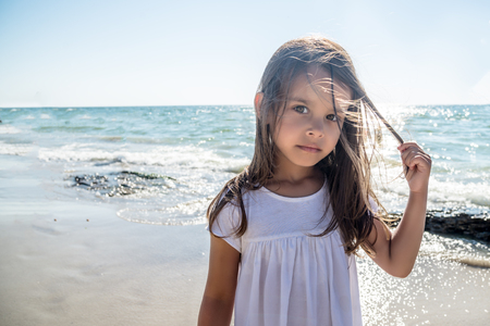 Closeup Portraie of Happy little girl on the beach.の写真素材