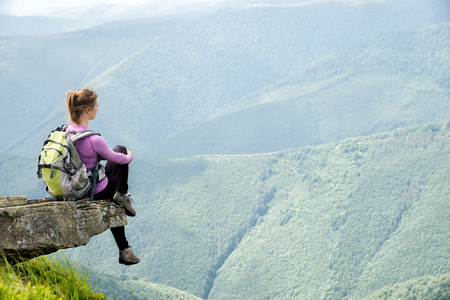 Young woman hiking in the mountainsの写真素材