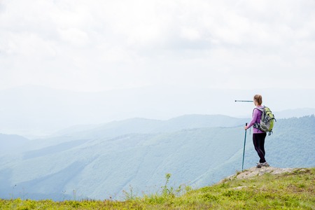 Young woman hiking in the mountainsの写真素材