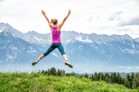 young woman on top of the mountainの写真素材