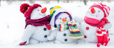 Happy snowman family with hats n the snowの写真素材