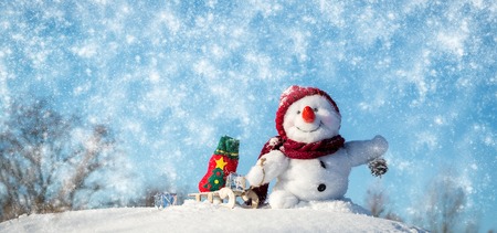 Happy snowman with hat in the snowの写真素材