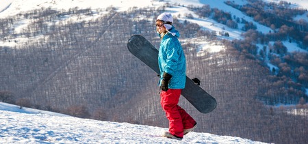 Young woman with snowboardの写真素材