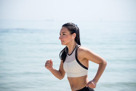 Fitness Girl running on the beachの写真素材