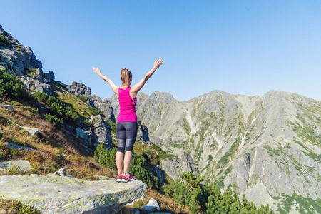 Young woman hiking in the mountainsの写真素材