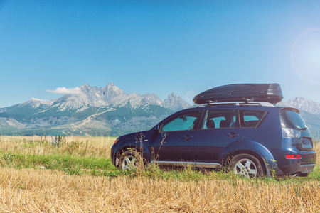 car for traveling with a roof rack on a mountain roadの写真素材
