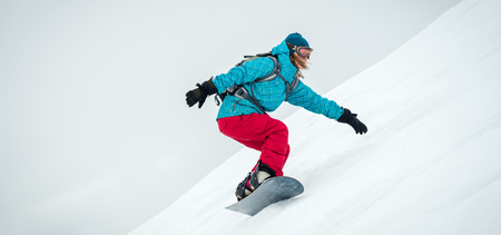 Young woman on the snowboardの写真素材