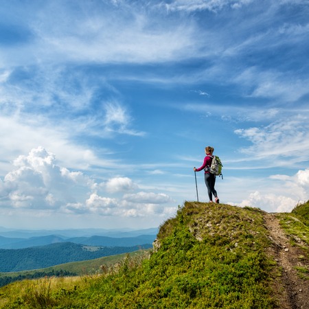 Young woman hiking in the mountainsの写真素材