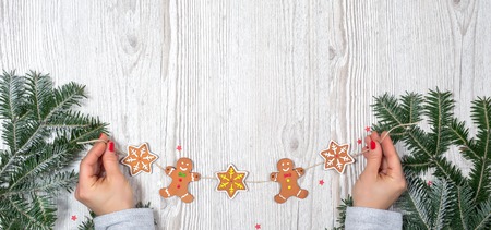 Gifts in hands with decorated Christmas backgroundの写真素材