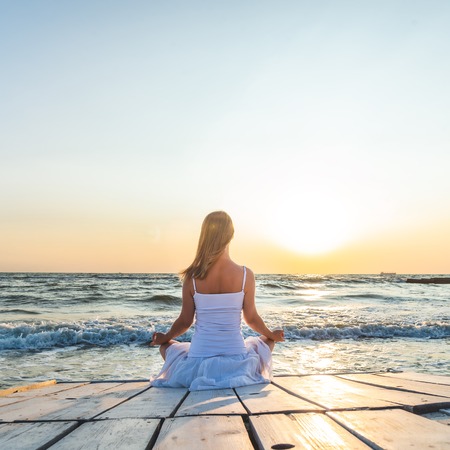 serenity and yoga practicing at the sea. sunriseの写真素材