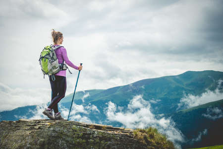 Young woman n the top of the mountainsの写真素材