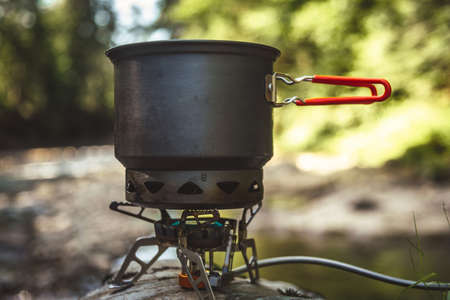 Cooking food using camping gas during the hike.の写真素材