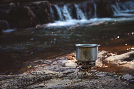 Cooking food using camping gas during the hike.の写真素材