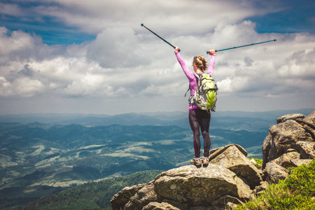 Young woman n the top of the mountainsの写真素材