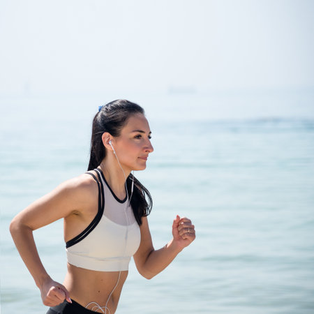 Fitness Girl running on the beachの写真素材