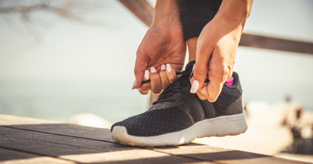 feet running on road closeup on shoeの写真素材