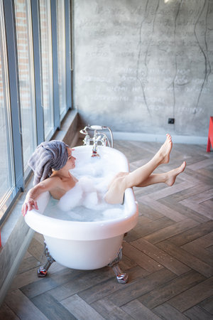 Woman feet in bathrobe at hotel room, closeup