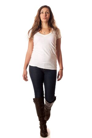 Casual young woman walking. Studio shot over white.の写真素材