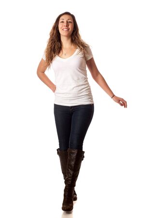 Casual young woman walking. Studio shot over white.の写真素材